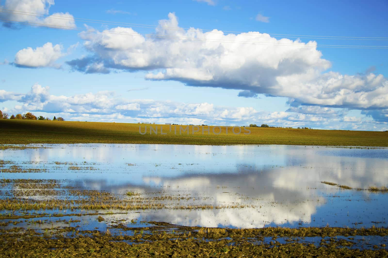 Landscape of the valley in Europe, Cloudy sky and autumn colors, water reflection. by Taidundua