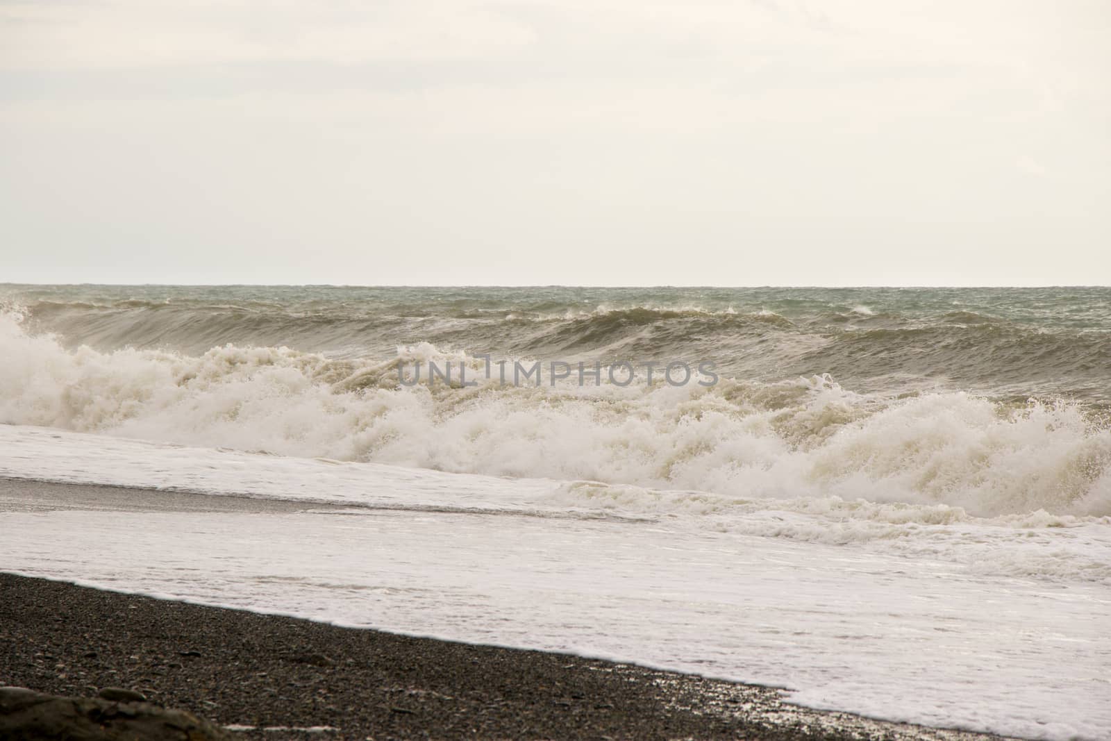 Stormy wheater, waves and splashes in Batumi, Georgia. Stormy Black sea. Water background.