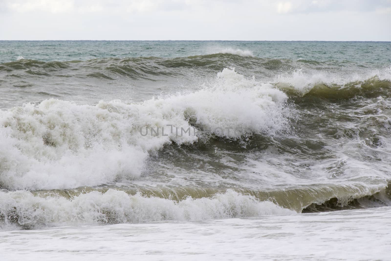 Stormy wheater, waves and splashes in Batumi, Georgia. Stormy Black sea. Water background.