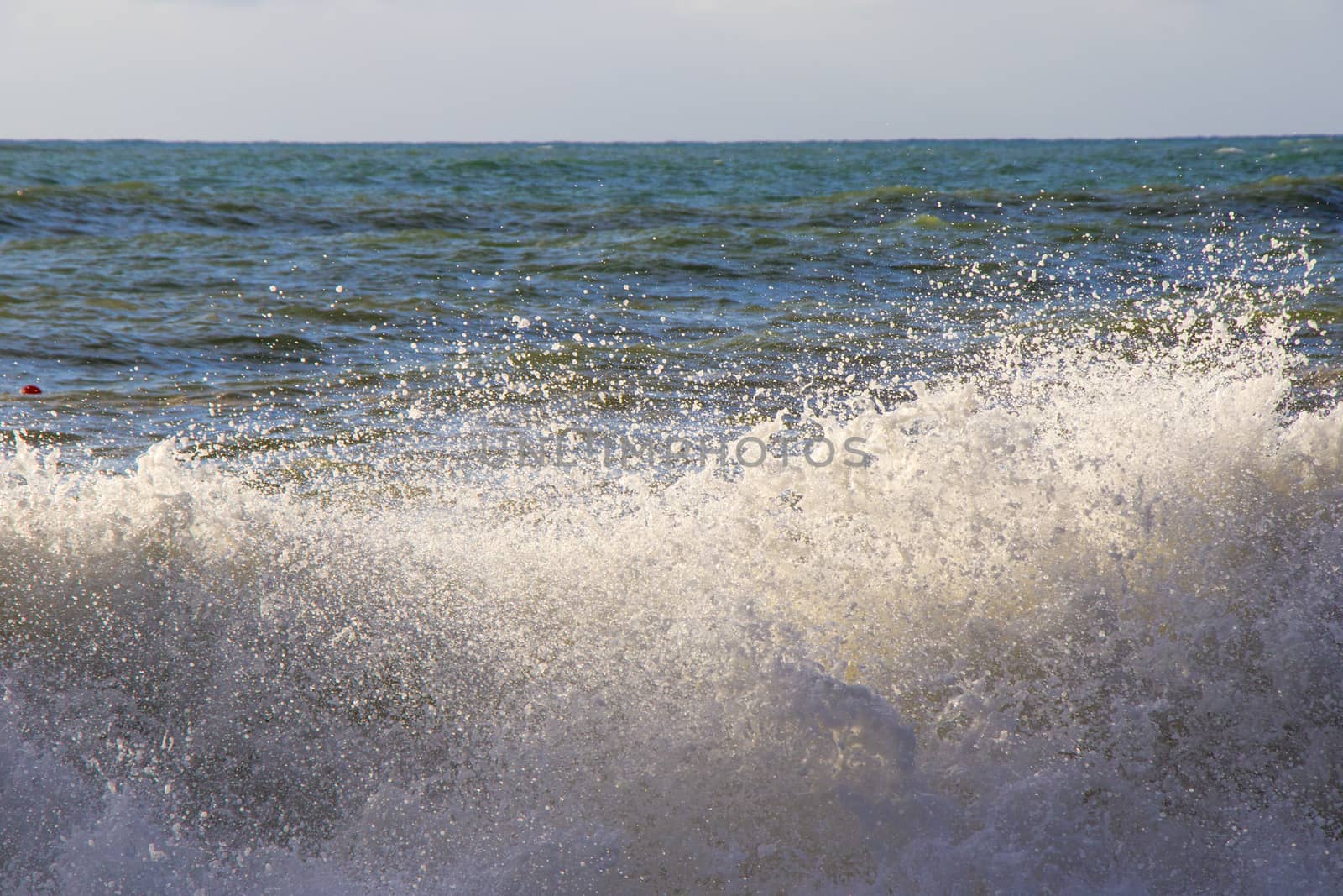 Stormy weather, waves and splashes in Batumi, Georgia. Stormy Black sea. Water background.