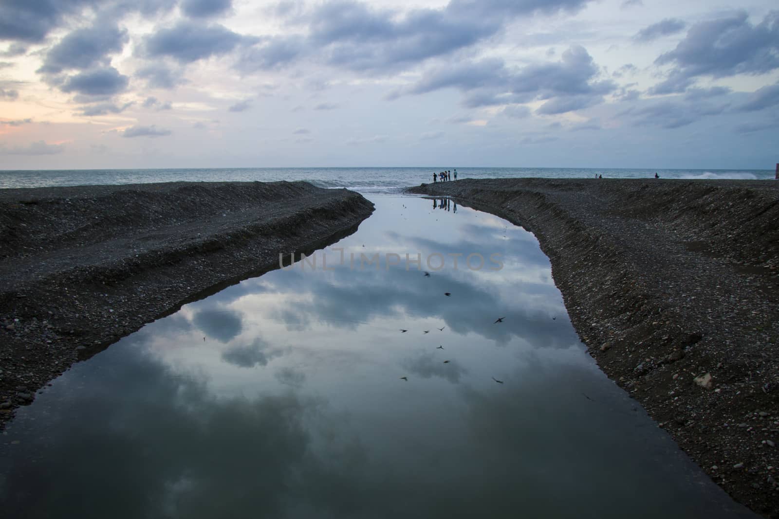 Black sea beach in Batumi, Georgia. People during holidays and vacation. Seascape and waves. by Taidundua