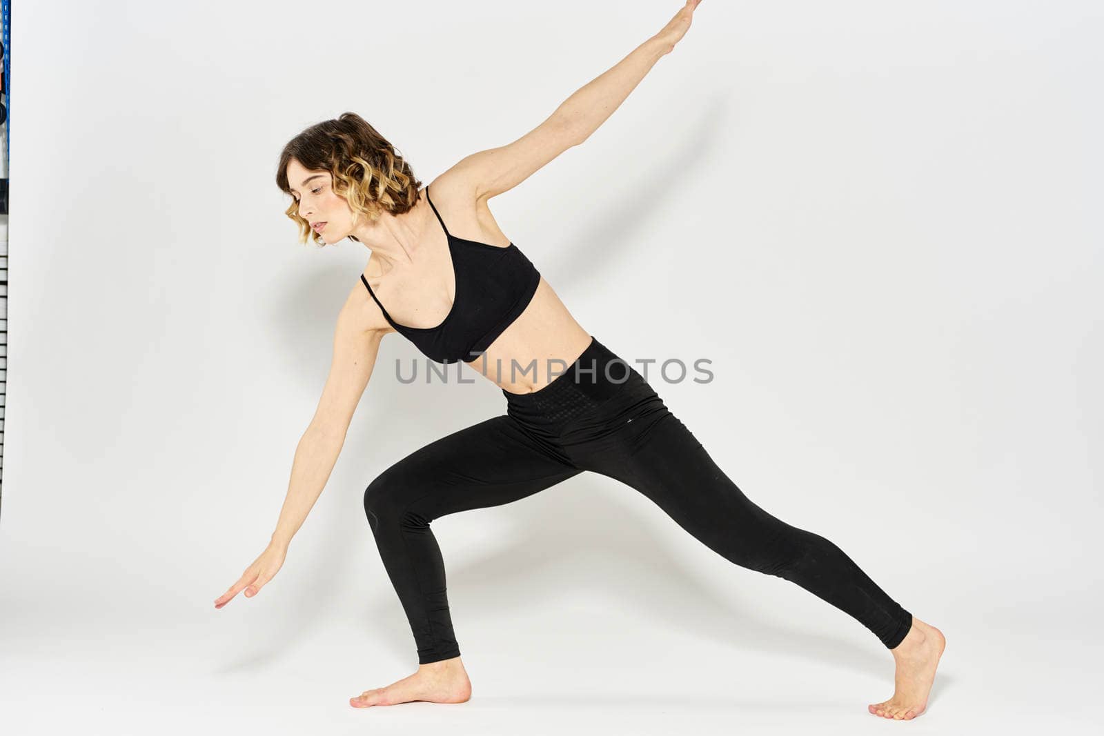 Woman in sportswear is engaged in fitness indoor gymnastics slim figure. High quality photo