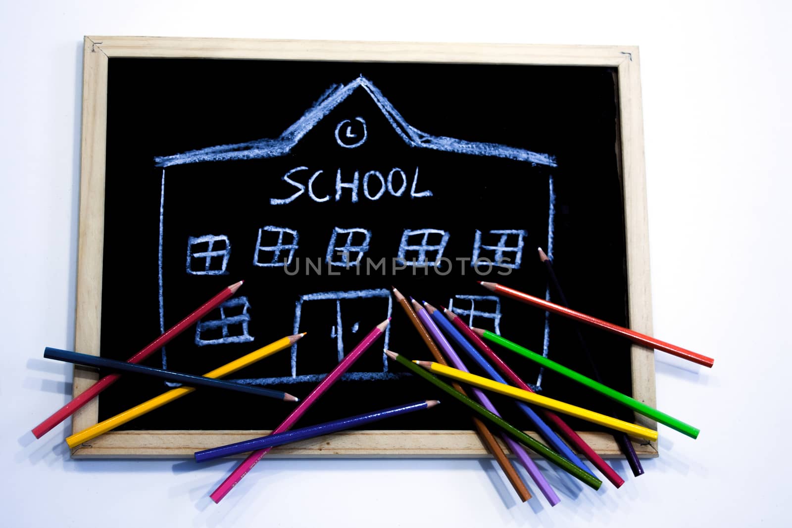 colored pencils on chalkboard with school drawn by Joanastockfoto