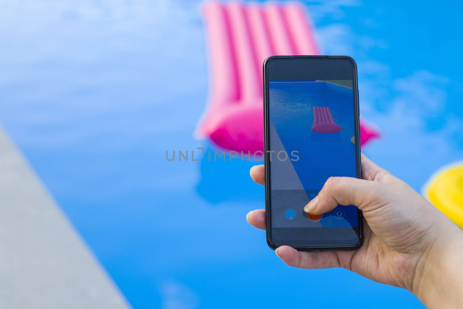 Take photo and video of swimming pool and pink mattress, summertime and empty pool, vacation and holiday, water background. Colorful summer background shooting scene.