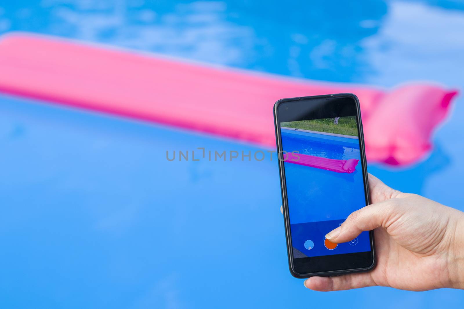 Take photo and video of swimming pool and pink mattress, summertime and empty pool, vacation and holiday, shooting scene. by Taidundua