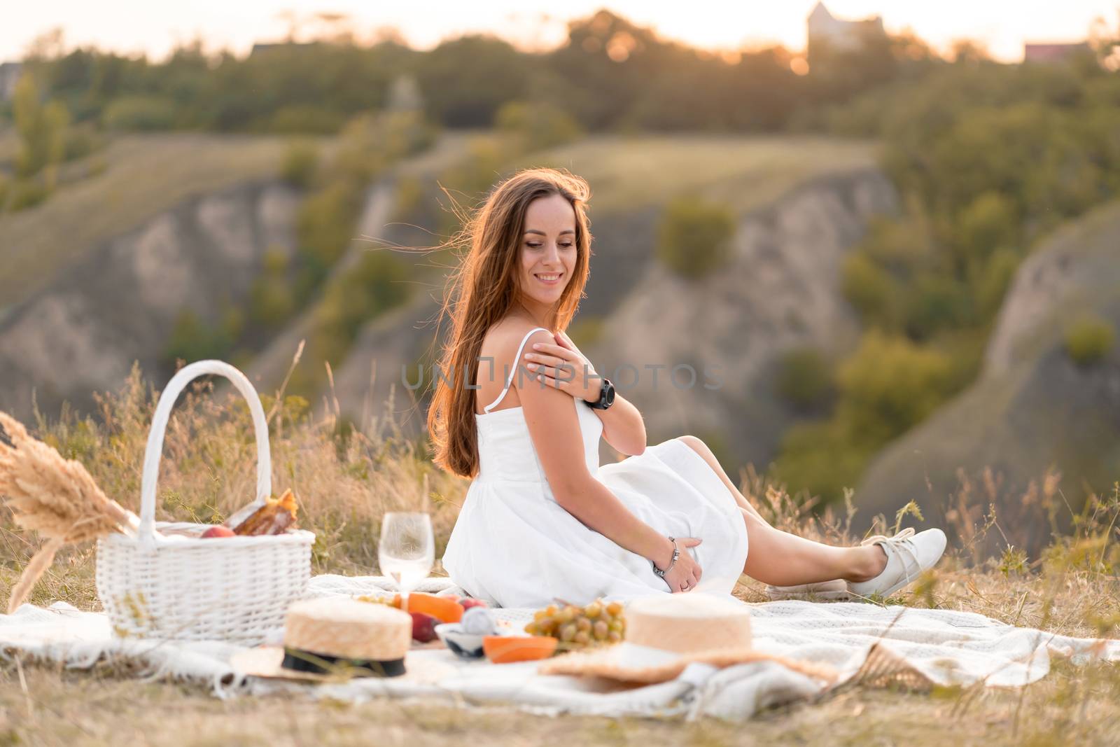 Gorgeous young brunette girl in a white sundress having a picnic by Try_my_best
