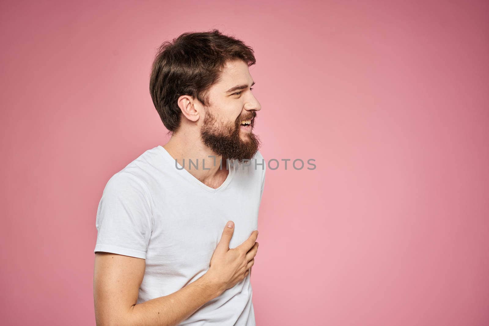 cheerful bearded man white t-shirt emotions cropped view pink background. High quality photo