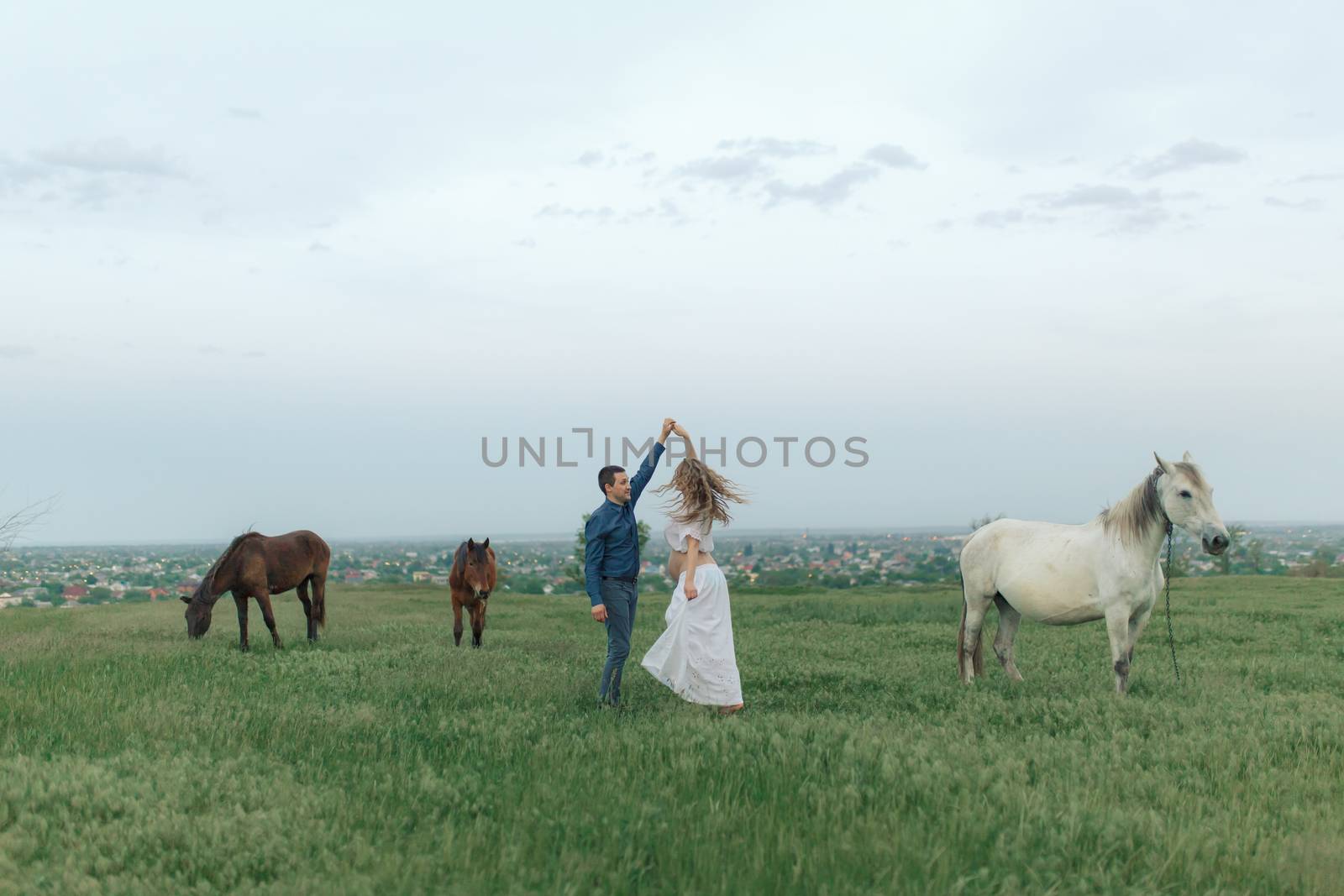 Rural couple on a green meadow communicates with animals. Pregnant wife. Therapy and relaxation for pregnant women by Try_my_best