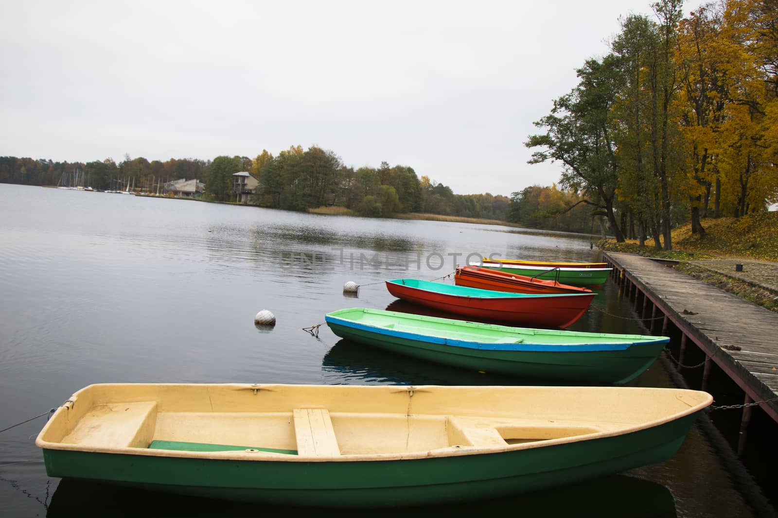 Old wooden boats near the beach of Trakai Gavle lake , Lithuania. Autumn and fall time.