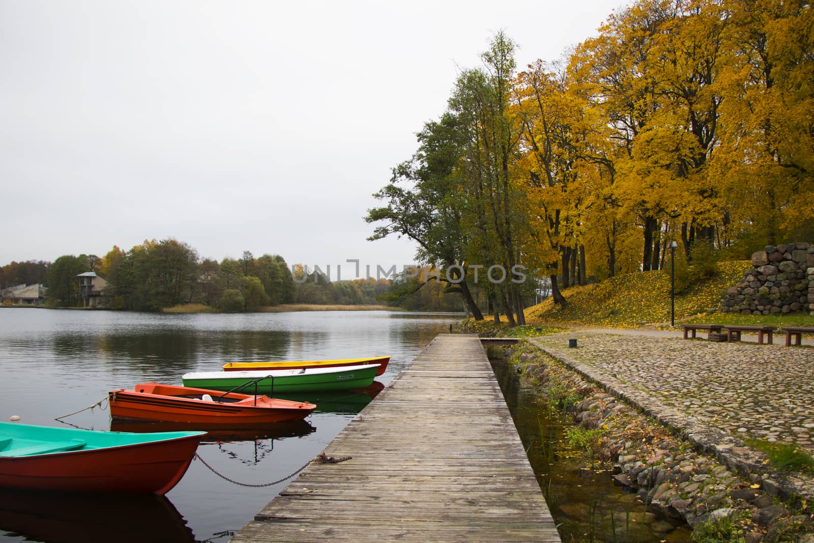 Old wooden boats near the beach of Trakai Gavle lake , Lithuania. Autumn and fall time.