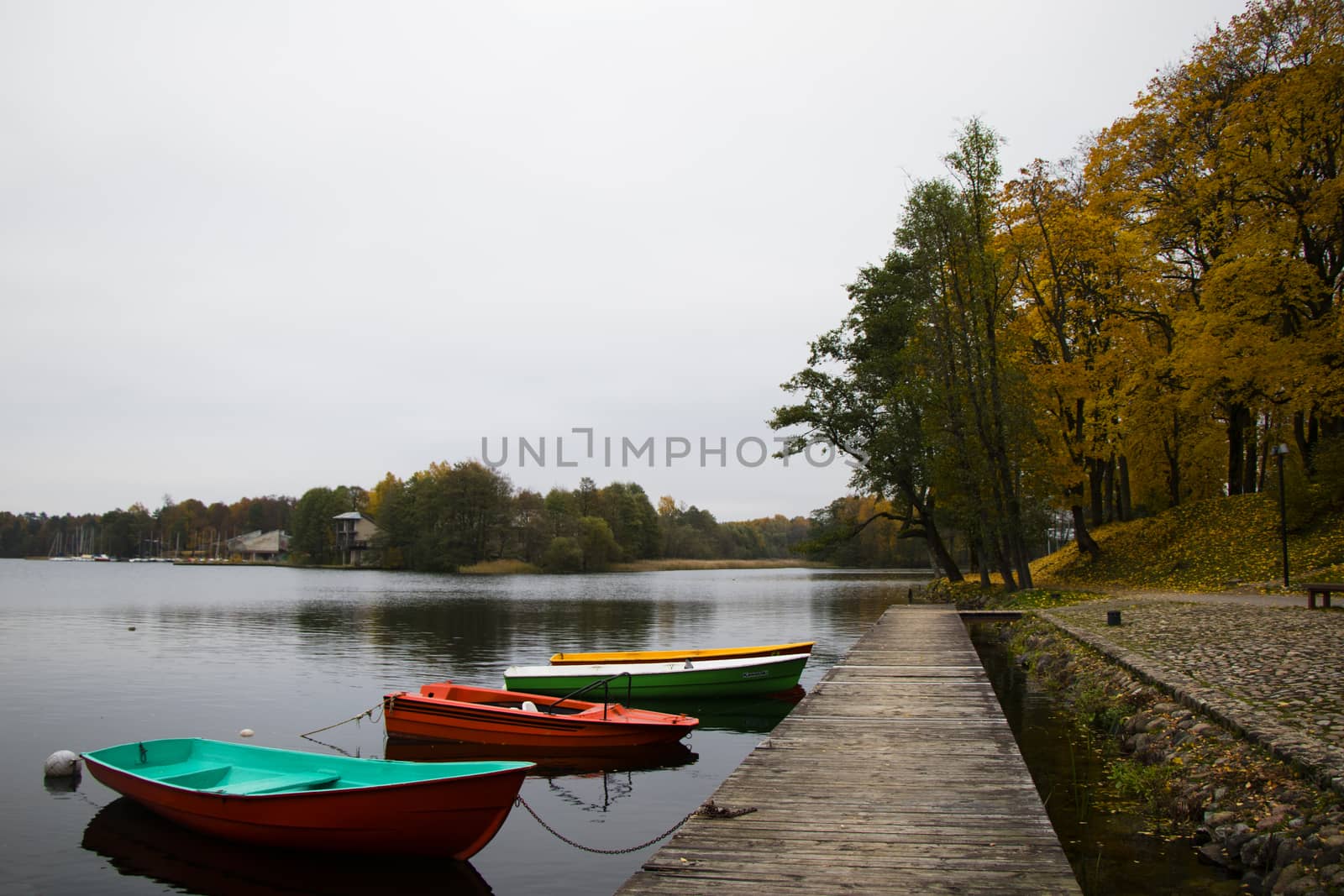Old wooden boats near the beach of Trakai Gavle lake , Lithuania. Autumn and fall time.