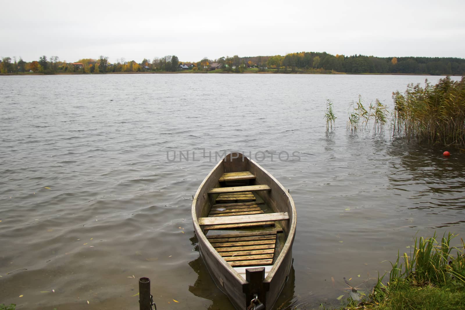 Old wooden boats near the beach of Trakai Gavle lake lake, Lithuania. Autumn and fall time.