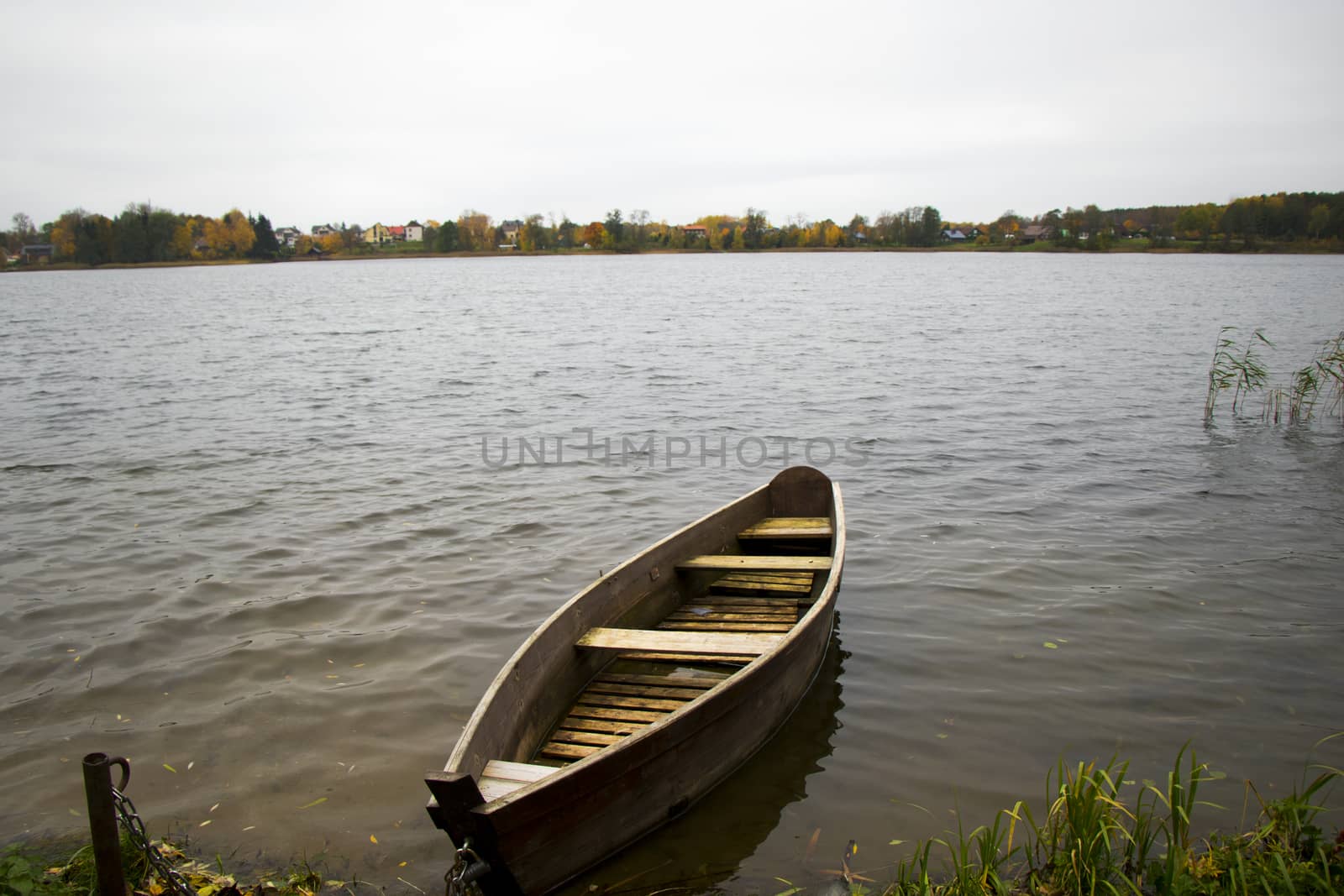 Old wooden boats near the beach of Trakai Gavle lake lake, Lithuania. Autumn and fall time.