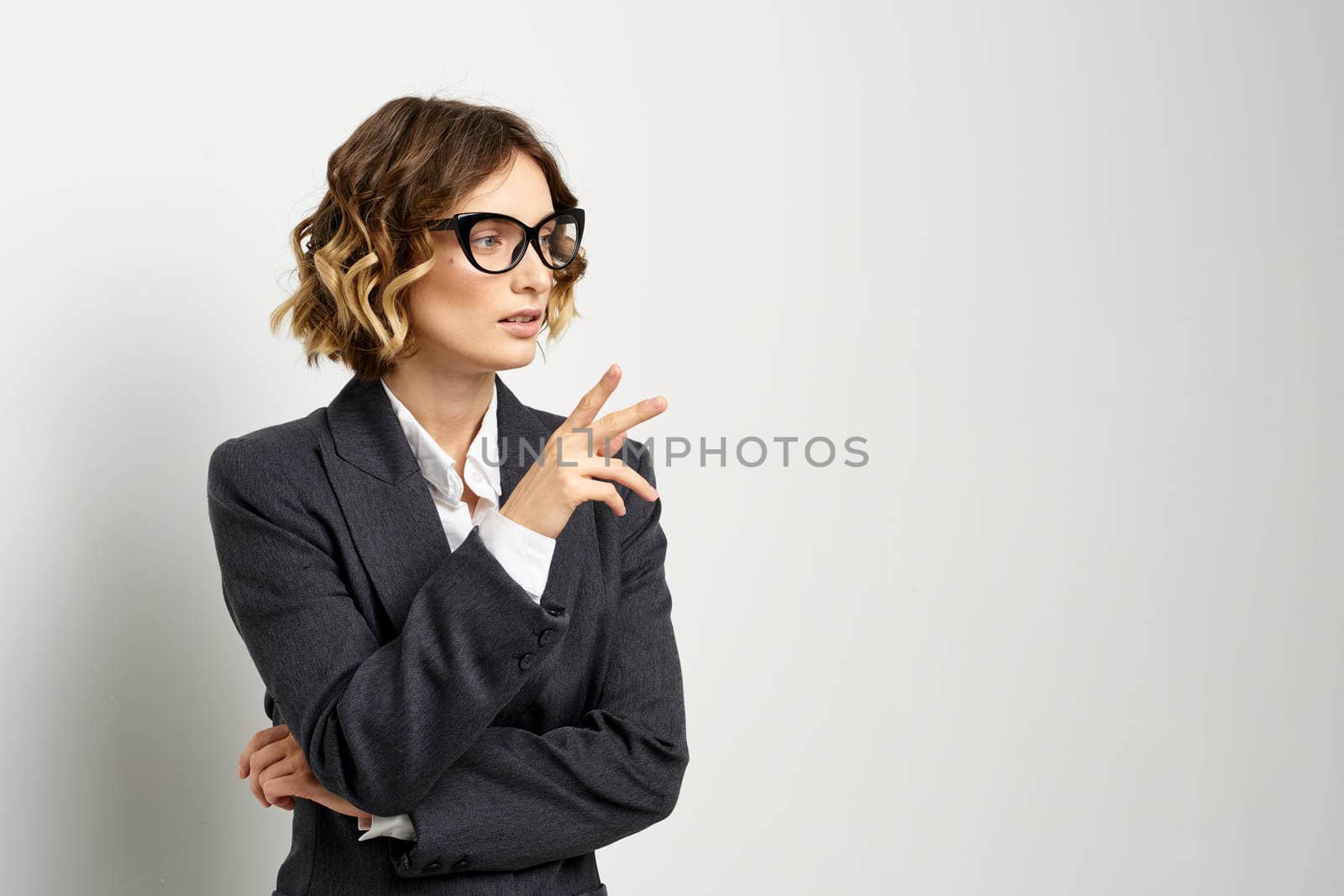 confident business woman in suit gesturing with hands work light background. High quality photo