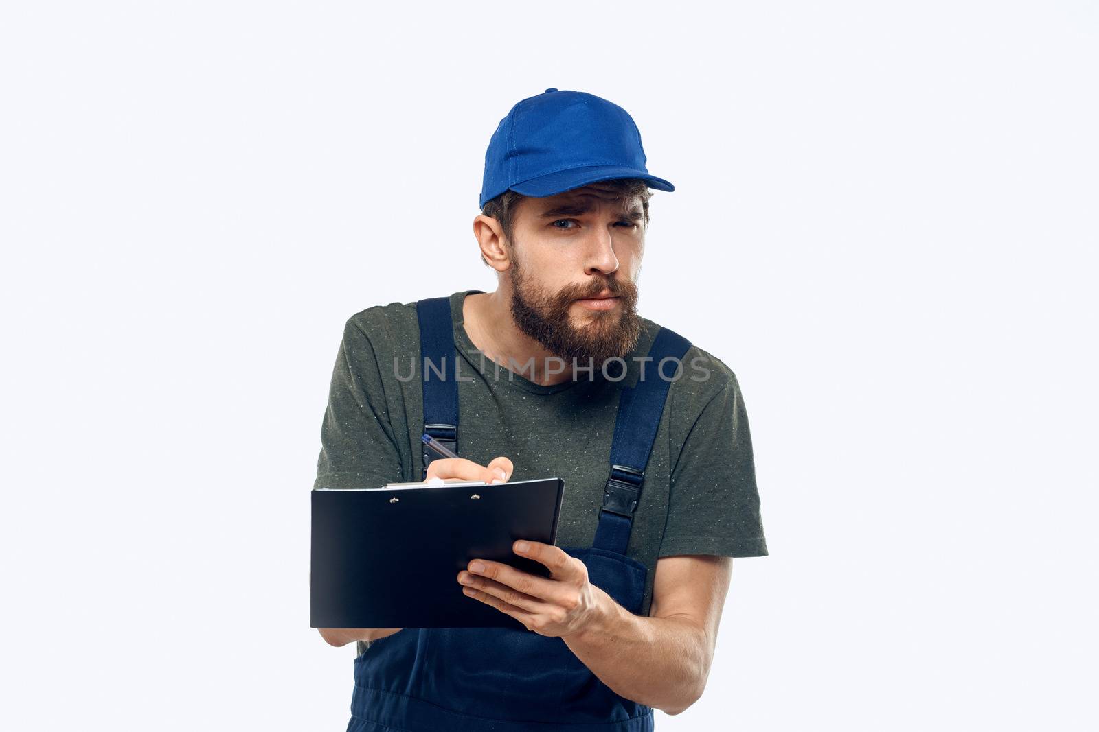 man in working uniform documents delivery loader transportation light background by SHOTPRIME