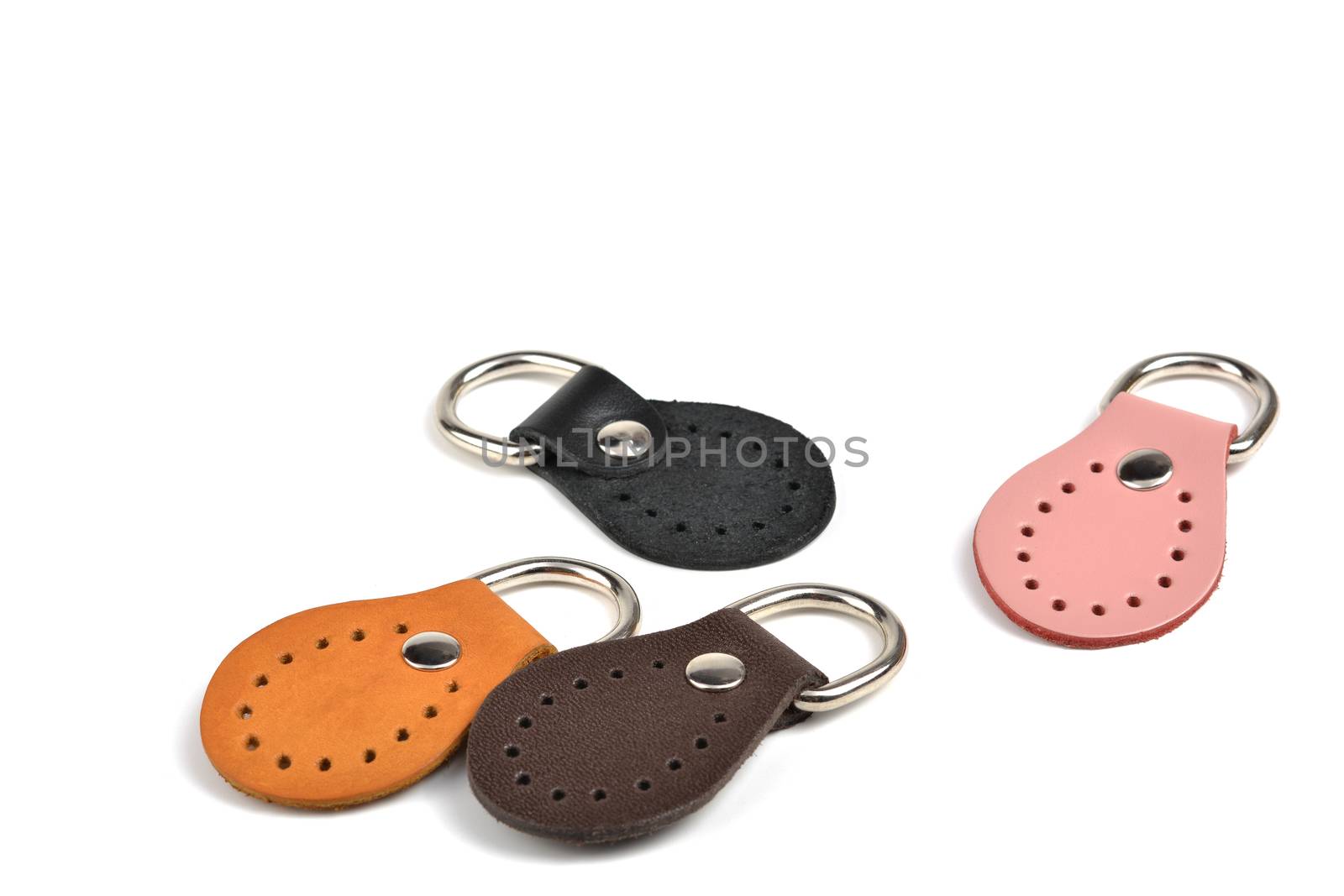 Blank round orange, black, pink, brown leather key chain collection on isolated white background with clipping path. Color set of metallic souvenir.