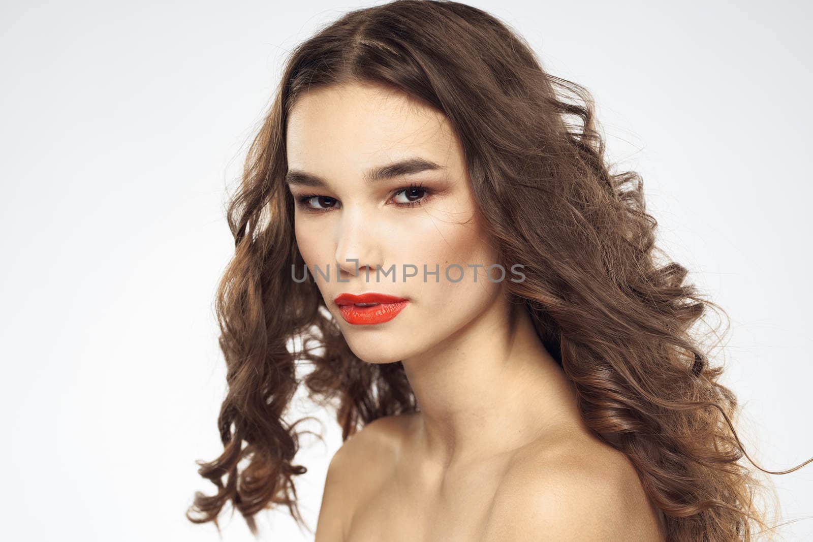 Elegant woman with bare shoulders red lips glamor attractive look cropped look. High quality photo