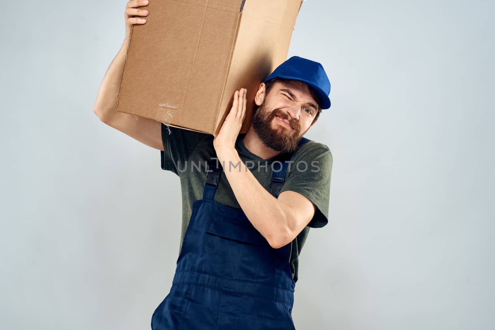 Male worker loading delivery boxes in hands packing lifestyle by SHOTPRIME
