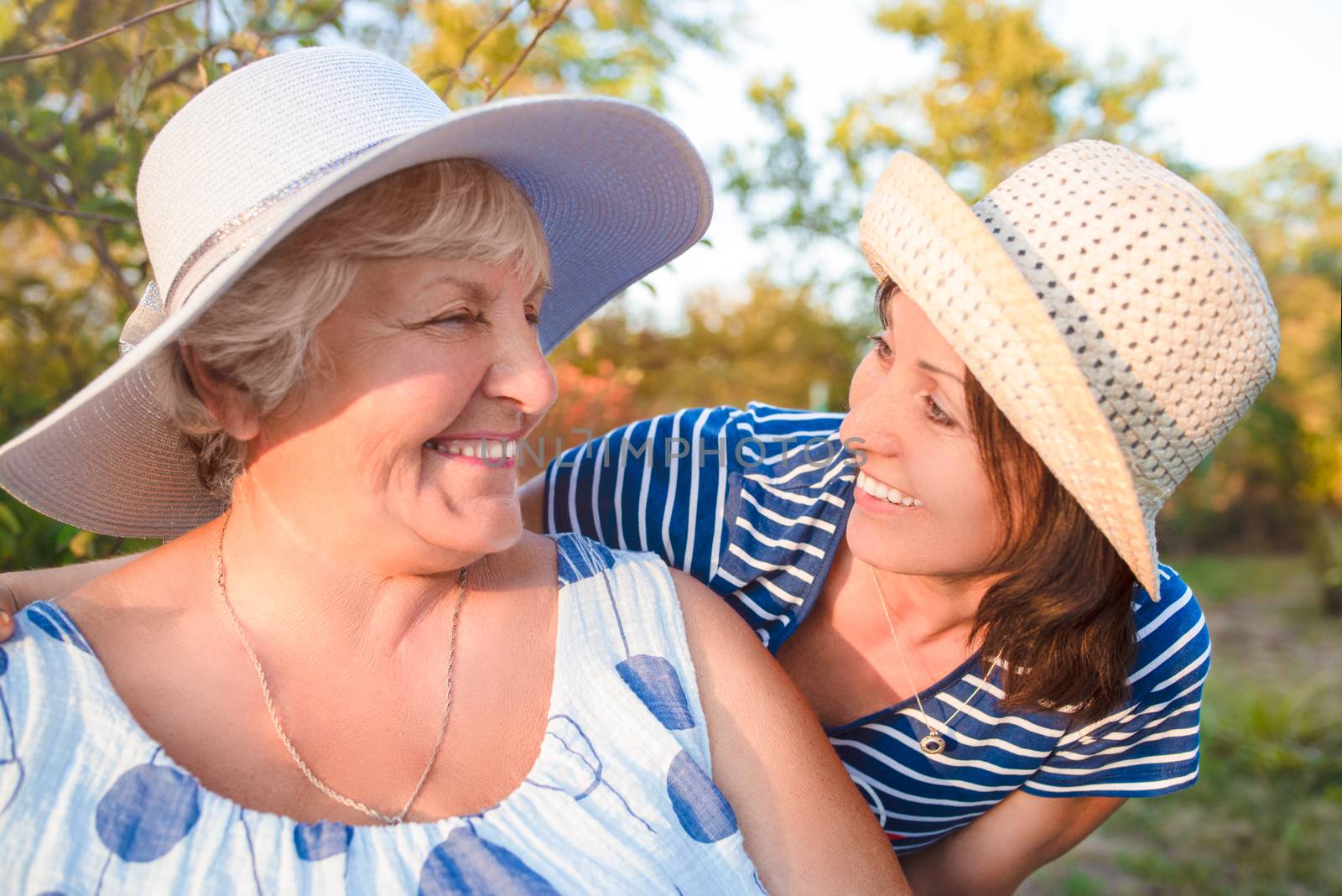 Happy daughter embracing her smiling mother.