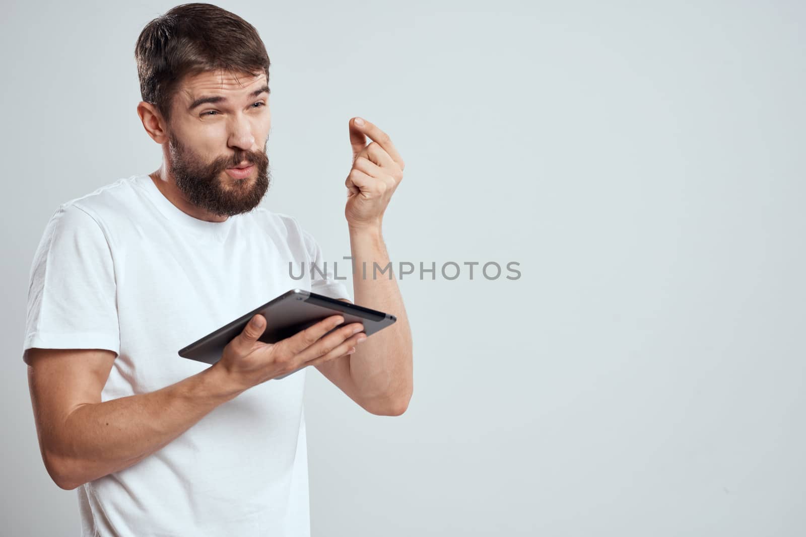emotional man with tablet in hand touch screen new technologies light background cropped view Copy Space by SHOTPRIME