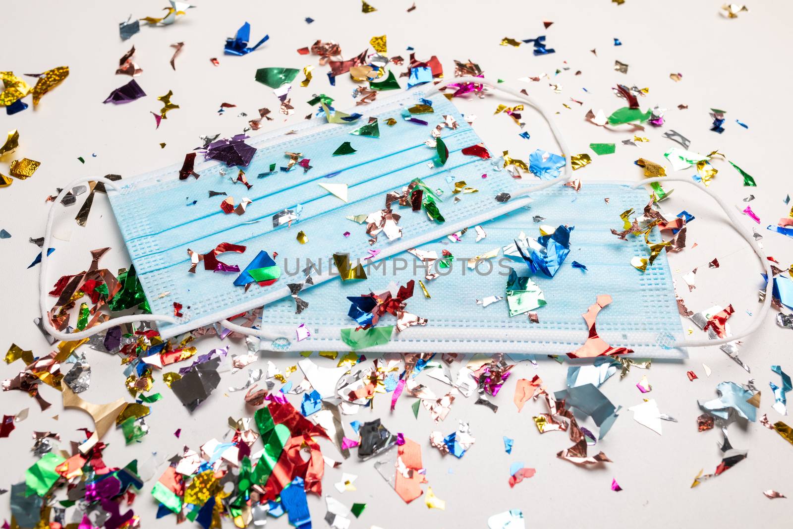 Facemask droped on flor with confetti after celebration new year 2021 party background stock image