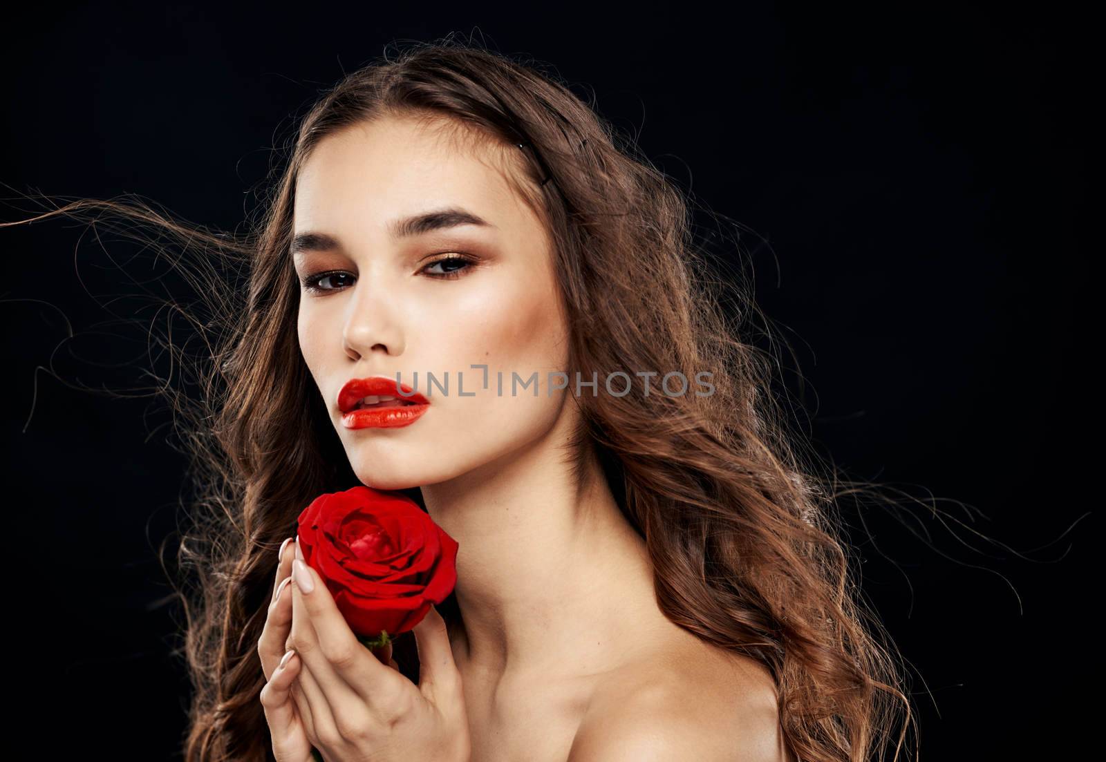 Charming woman with red rose eyeshadow bright makeup black background. High quality photo