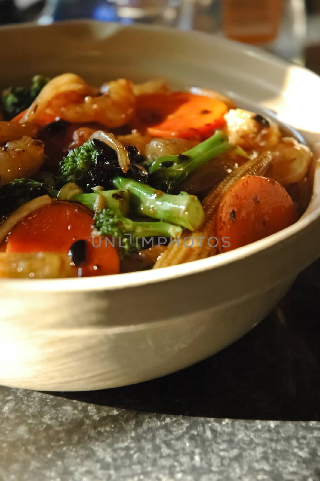 Vegetable stir-fried with black bean sauce on hot pot rice in Chinese restaurant