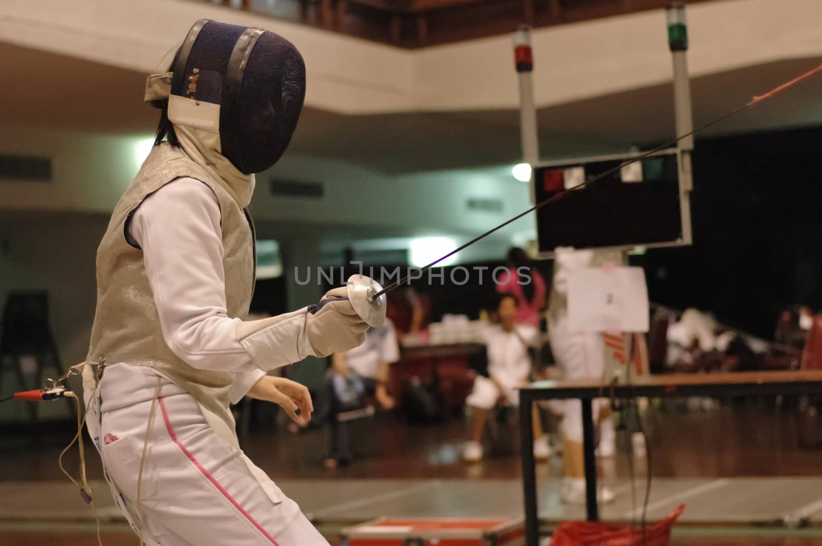 Foil fencing sport fighter on guard and ready to fight in the competition