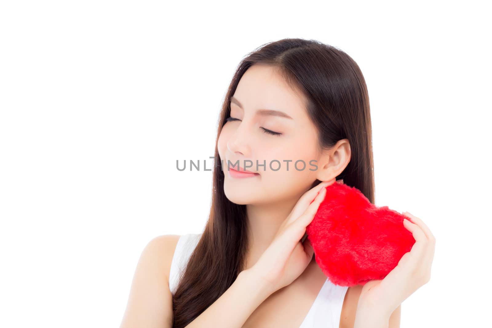 Portrait of asian young woman holding heart shape pillowand smile, valentines day, holiday concept.