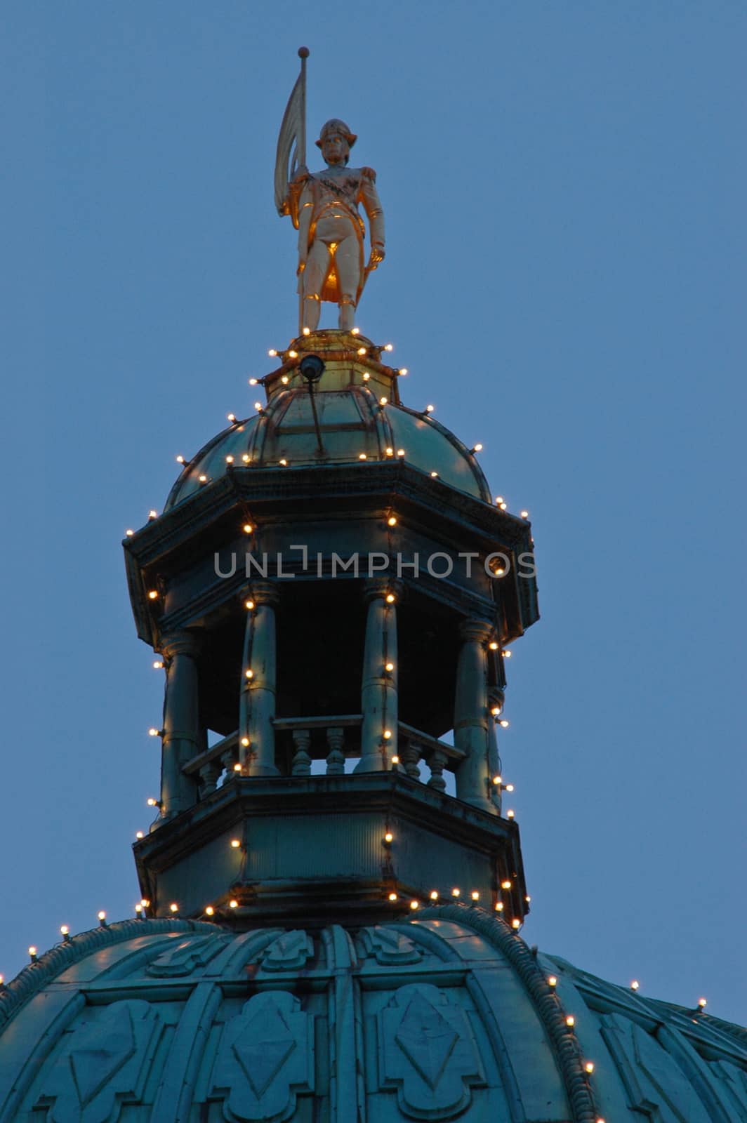 golden european statue on the dome by eyeofpaul