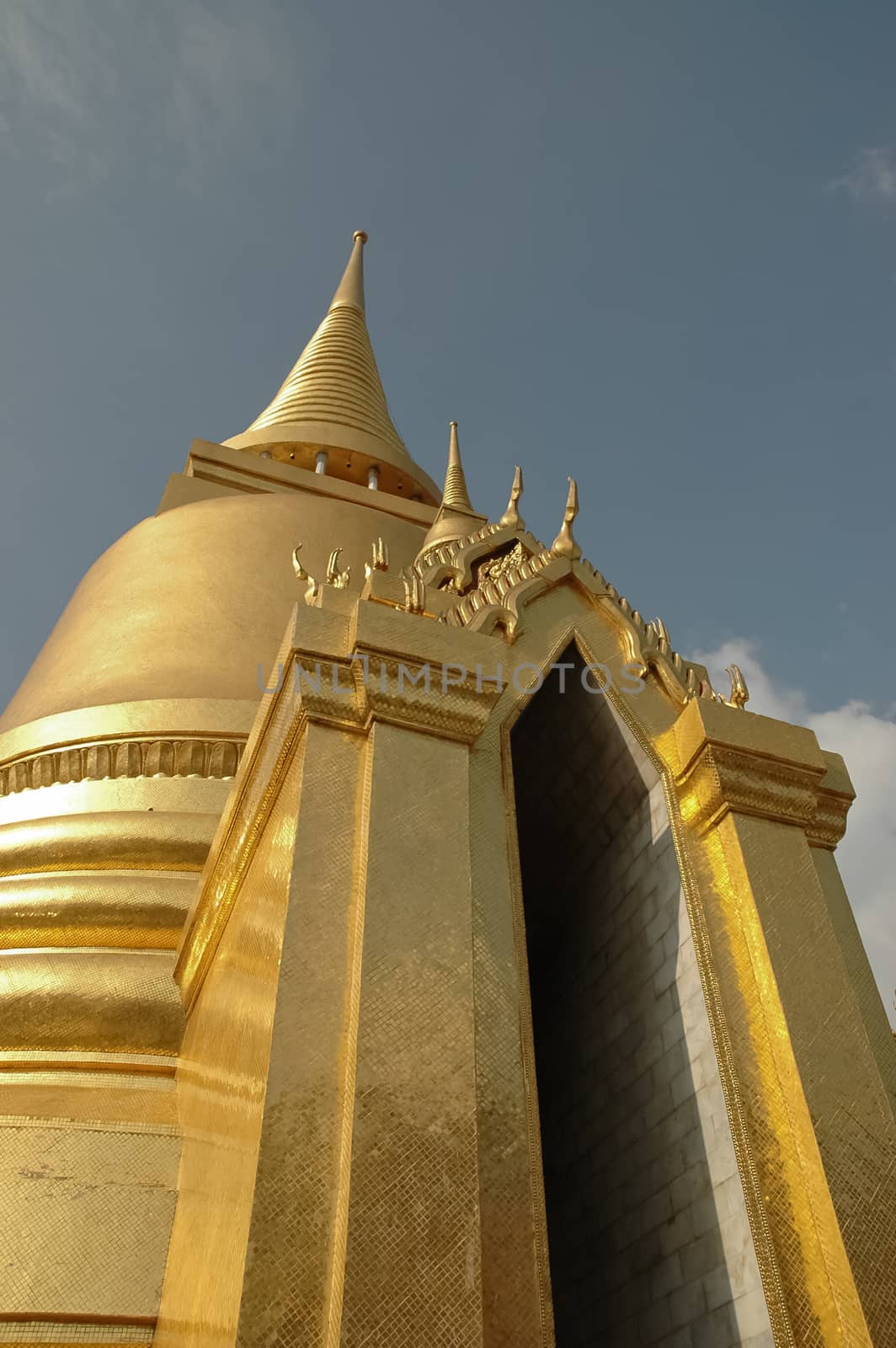 Golden stupa gate and blue sky in Bangkok Thailand by eyeofpaul