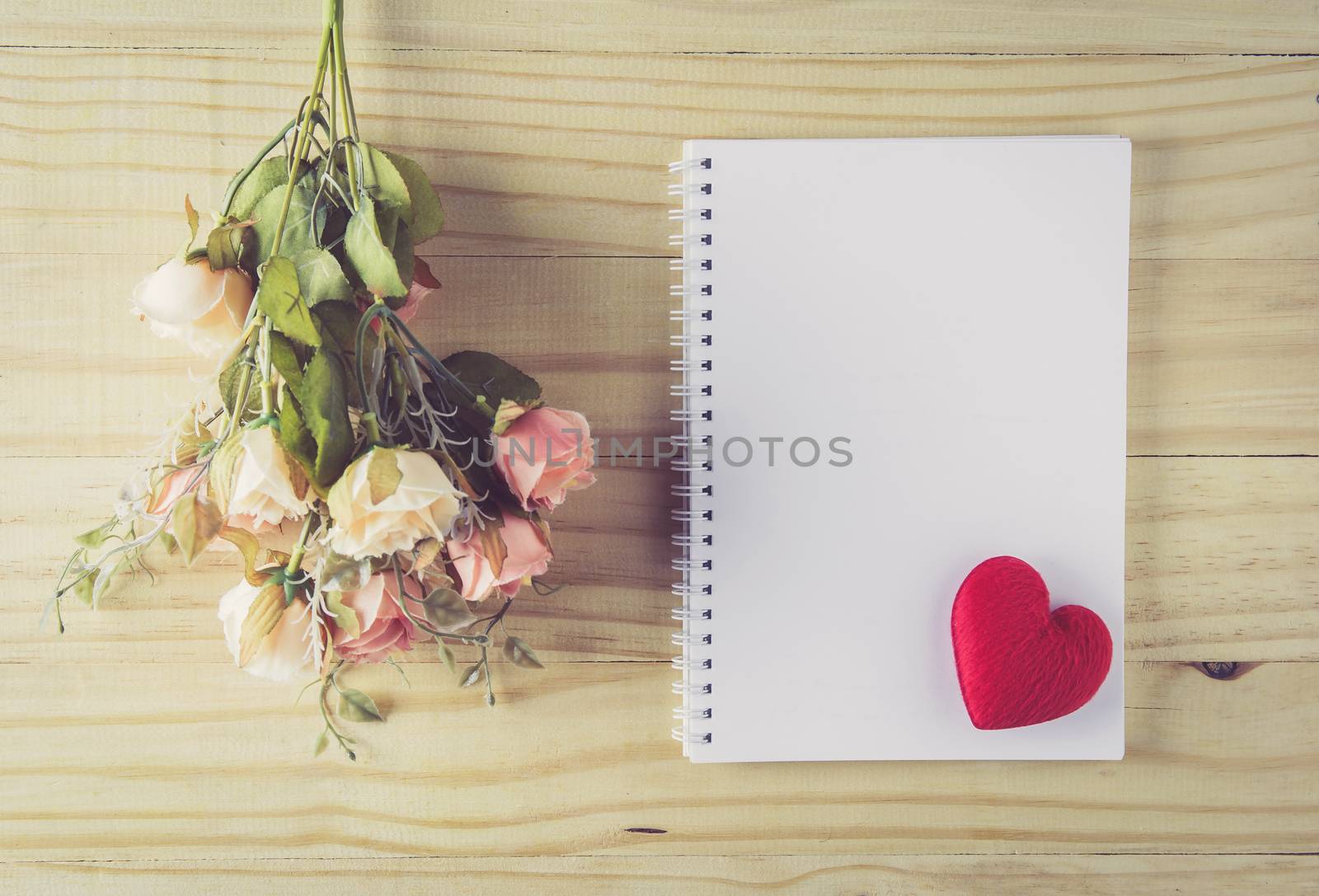 Vintage flower bouquet on wooden table with top view, romantic with love heart on paper for text copy sapce, valentine holiday concept.