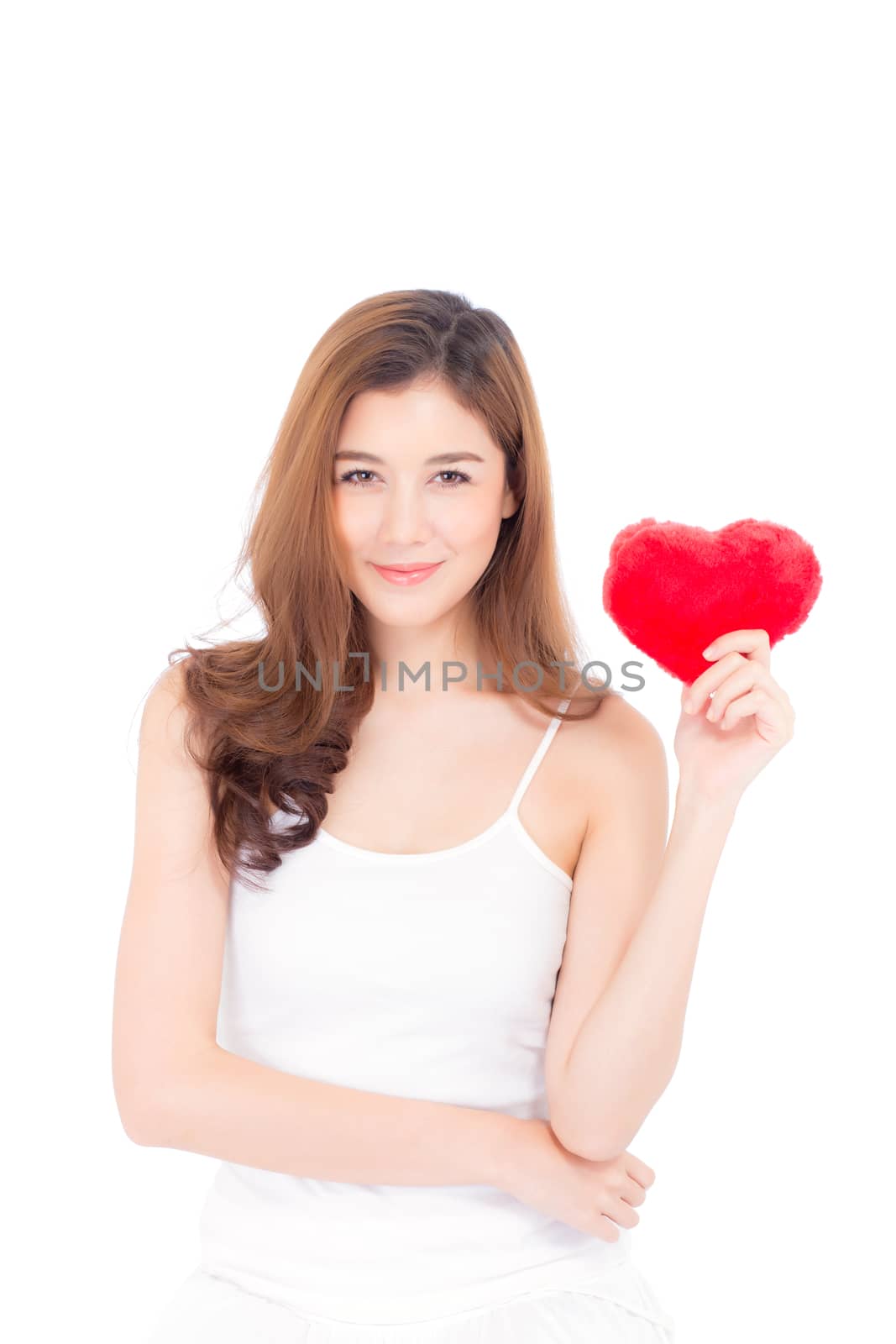 Portrait of beautiful asian young woman holding red heart shape pillow and smile isolated on white background, valentines day, holiday concept.