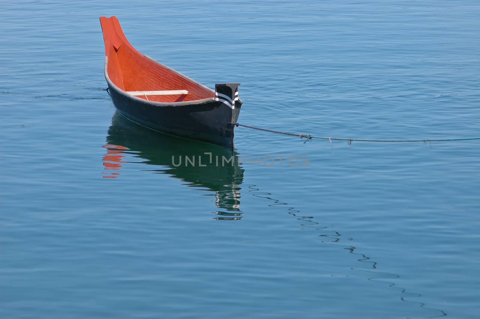 rowing boat floats on calm lake