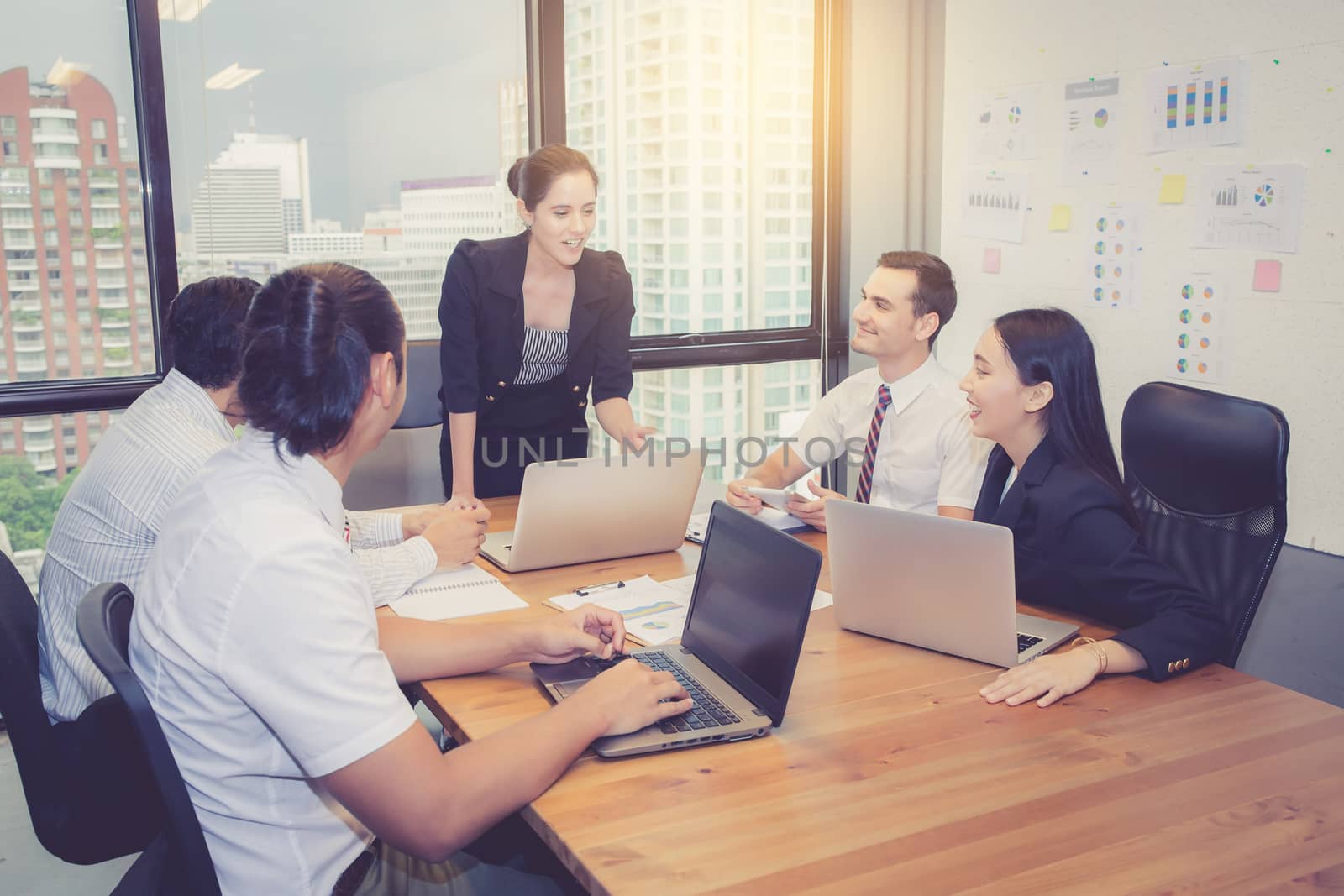 Group of young business team with woman manager standing leader meeting in conference room at modern coworkers office, teamwork and business concept.