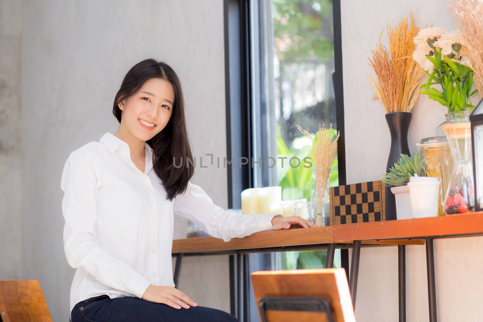 Beautiful of portrait asian young woman working online sitting at coffee shop, professional female freelancer relax and leisure, business concept.