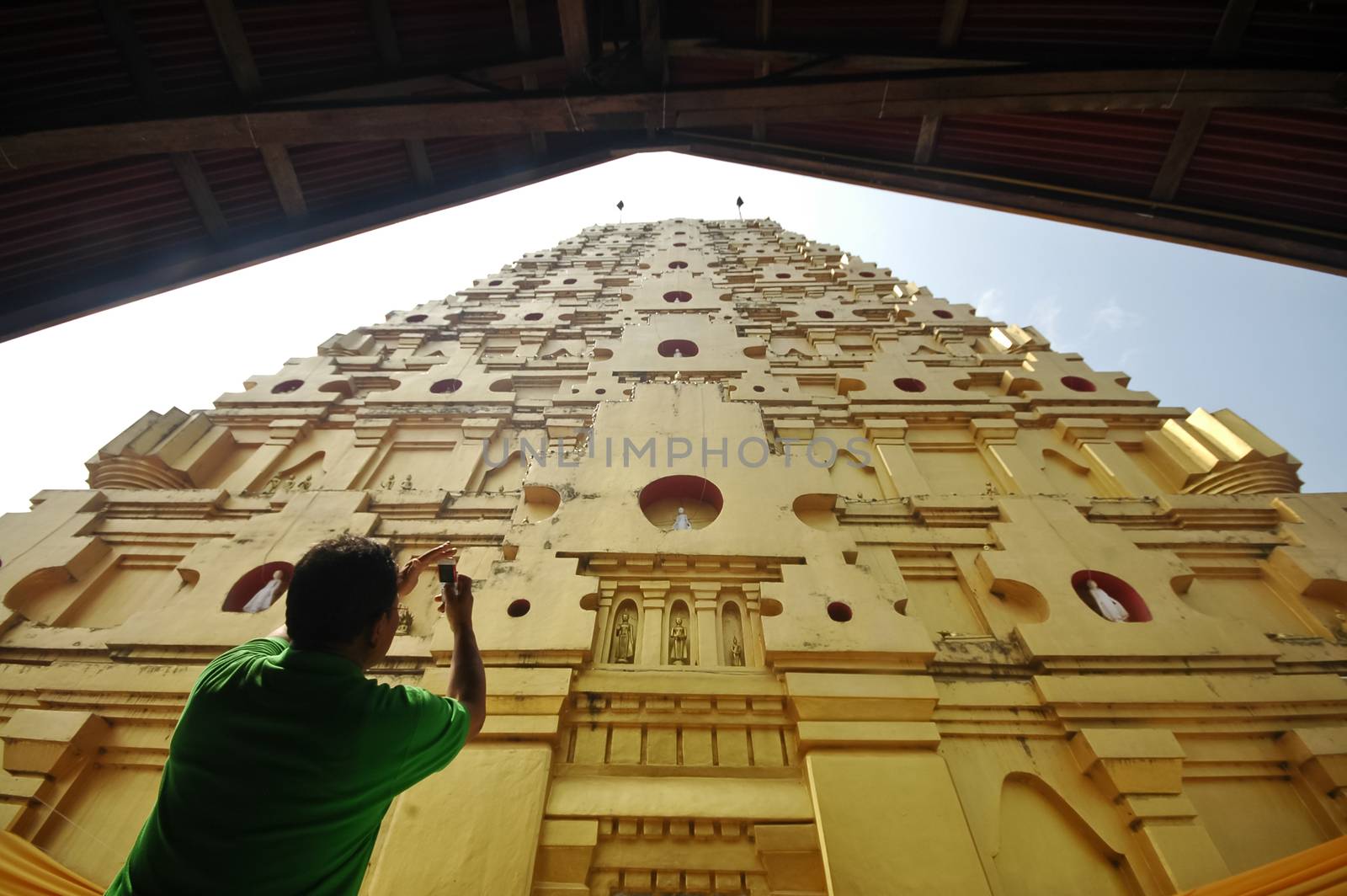 A man shooting photo for golden roof of Sangkhlaburi temple in W by eyeofpaul