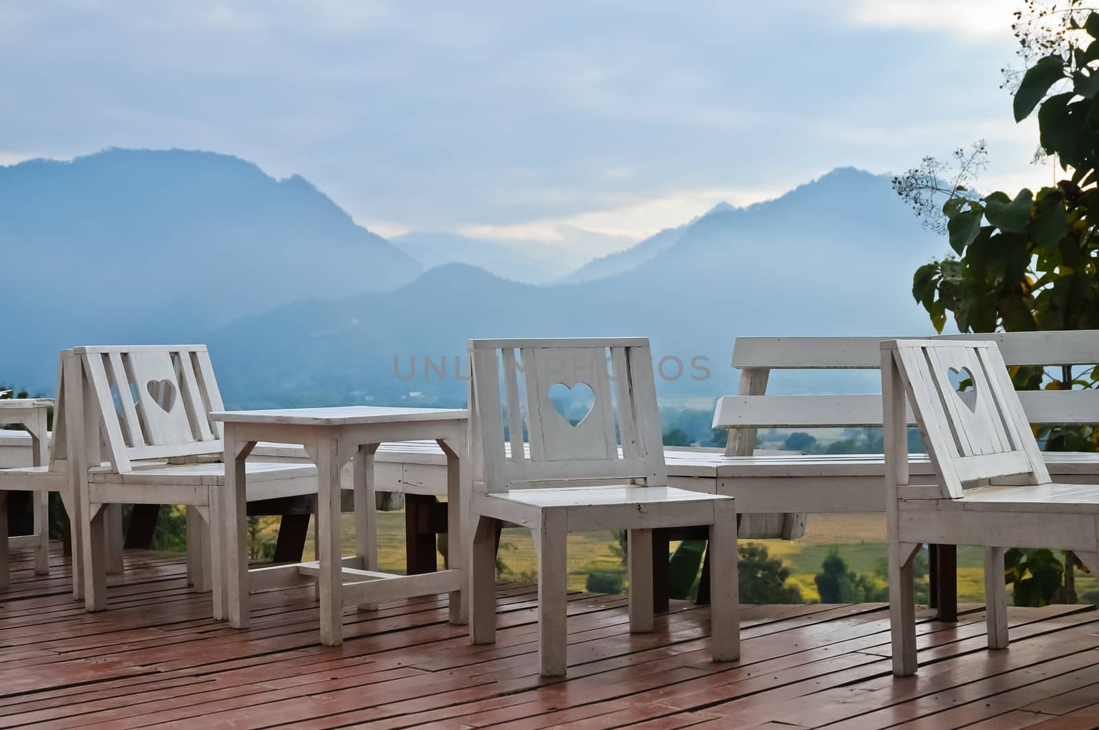 White wooden love chairs on balcony in hillside of Pai village Northern Thailand