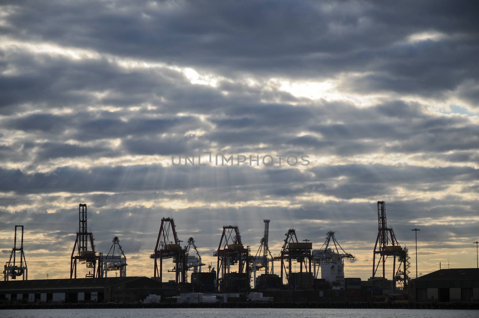 Heavy industry cranes in logistic bay area in the evening twilight scene