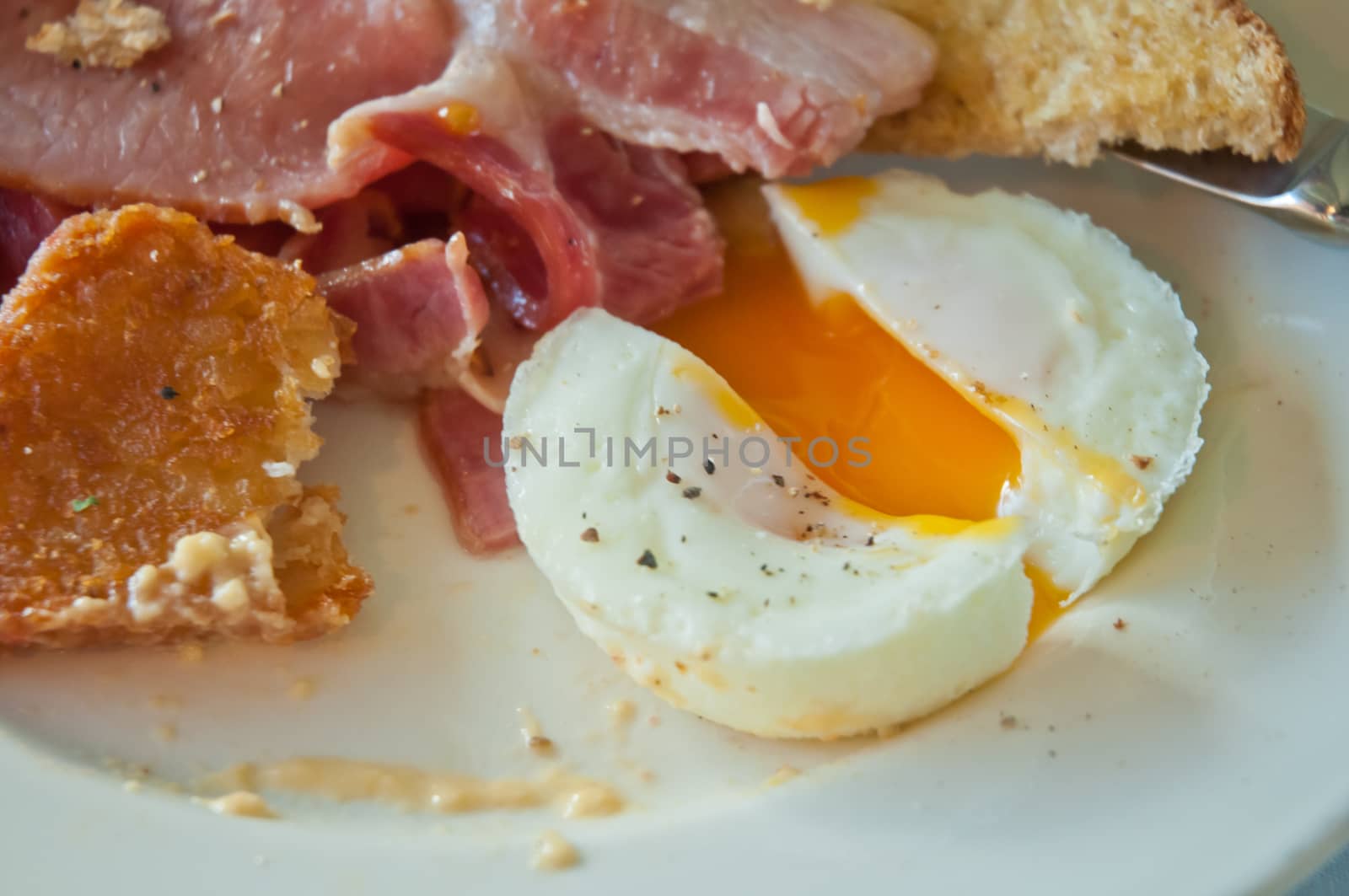 English breakfast - poached yummy half-cooked eggs and bacon by eyeofpaul