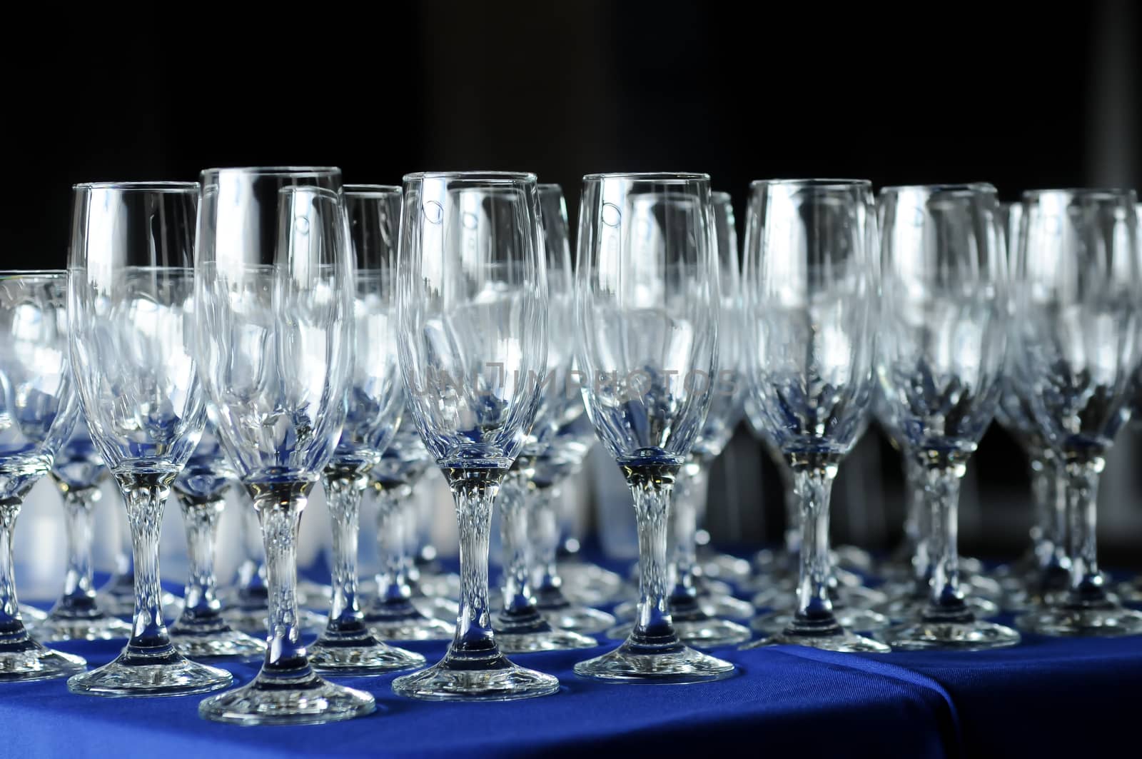 Many wine glasses on a party table by eyeofpaul