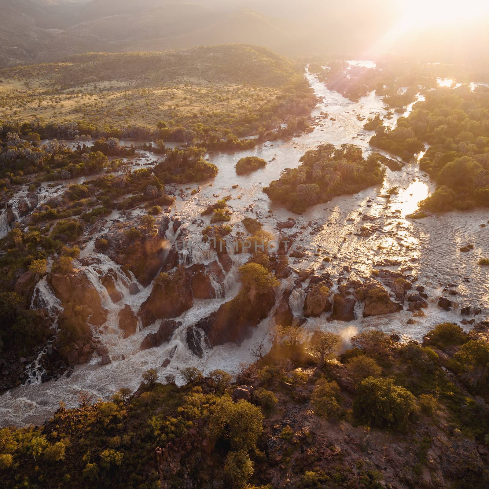 Epupa Falls full of water on the Kunene River, Northern Namibia and Angola border. Sunrise african landscape. Pure nature