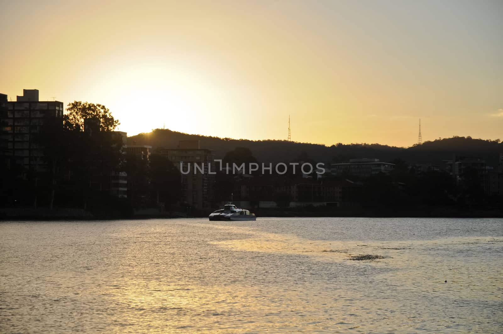 A ferry in Brisbane River at the sun set time by eyeofpaul