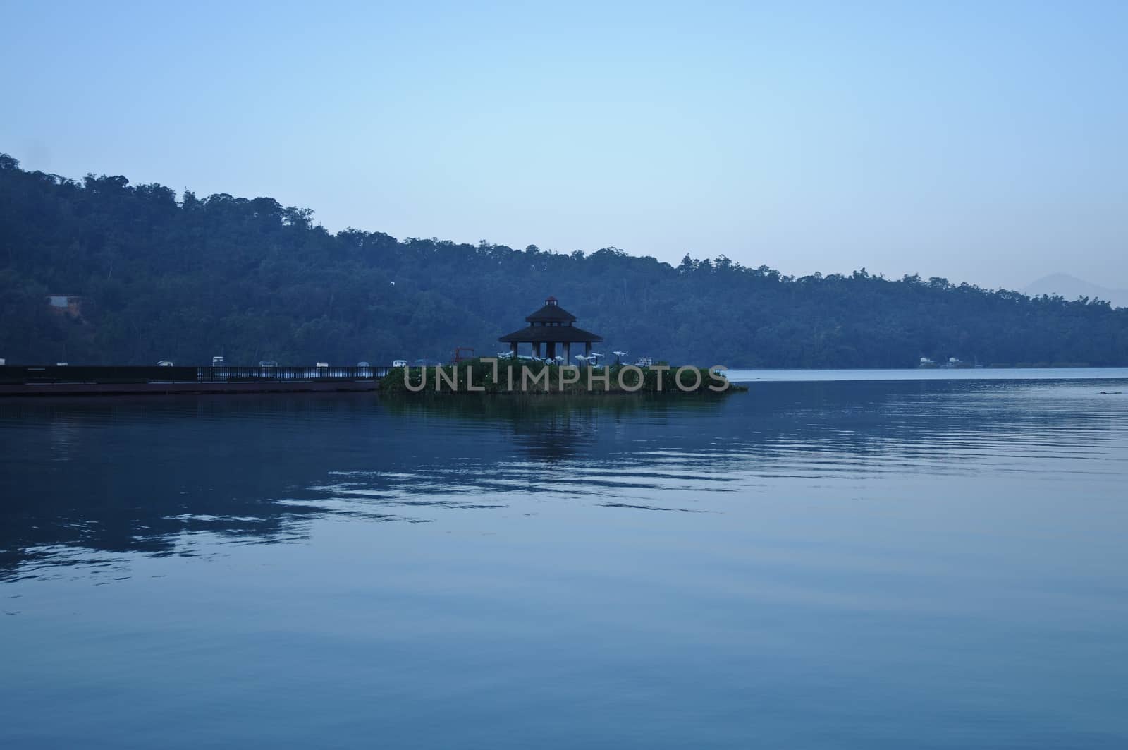 Chinese pavilion nearby the peaceful lake in early morning