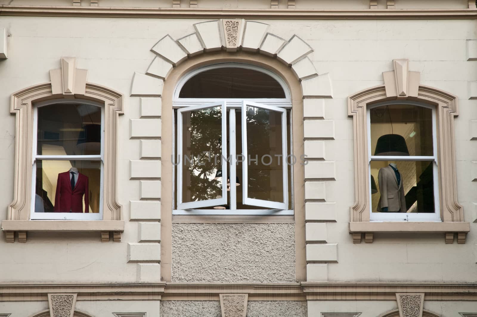 Windows of clothes shop showing red and white suits in Italy by eyeofpaul