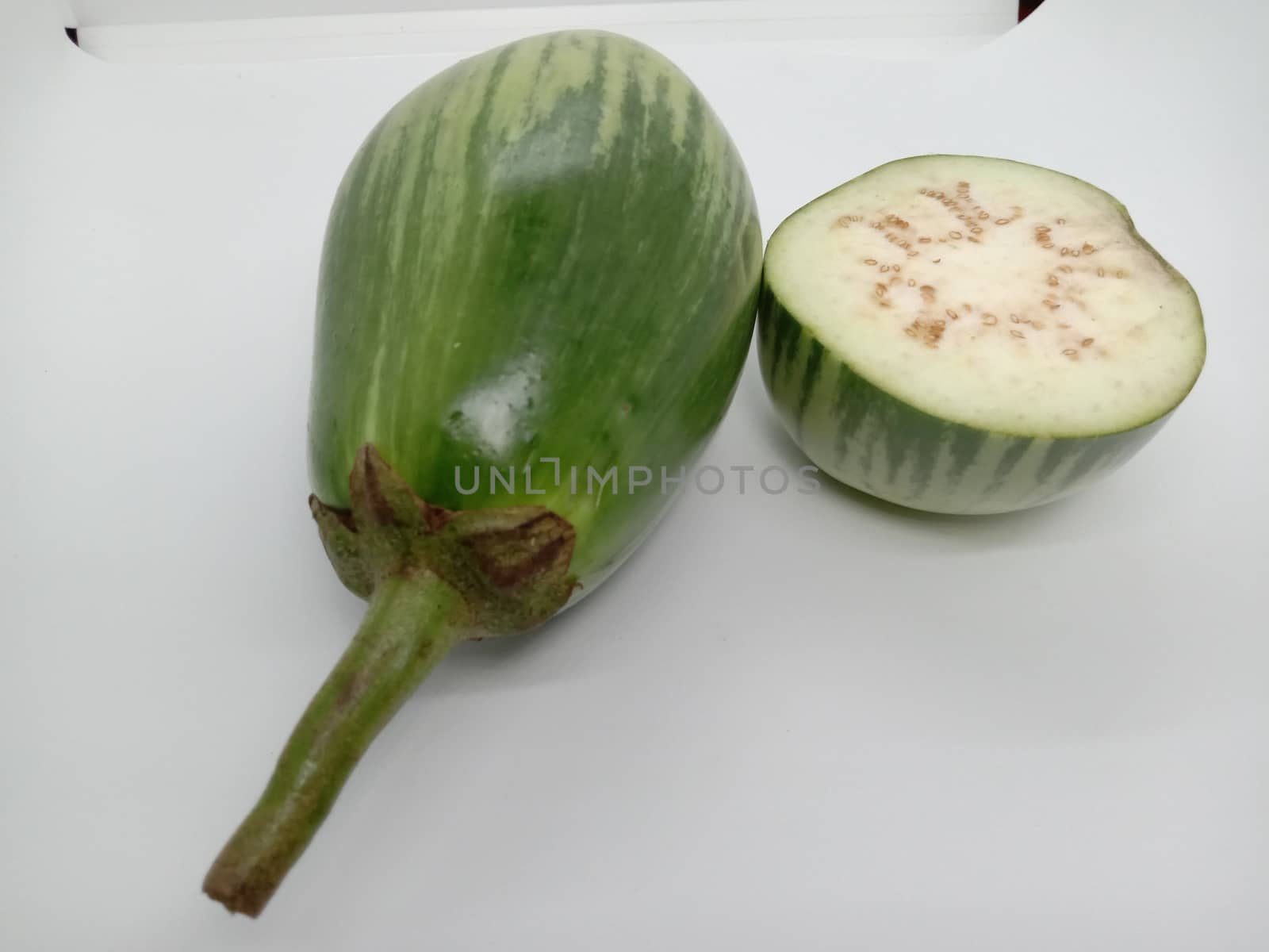 Fresh and healthy Raw Brinjal Closeup on White Background