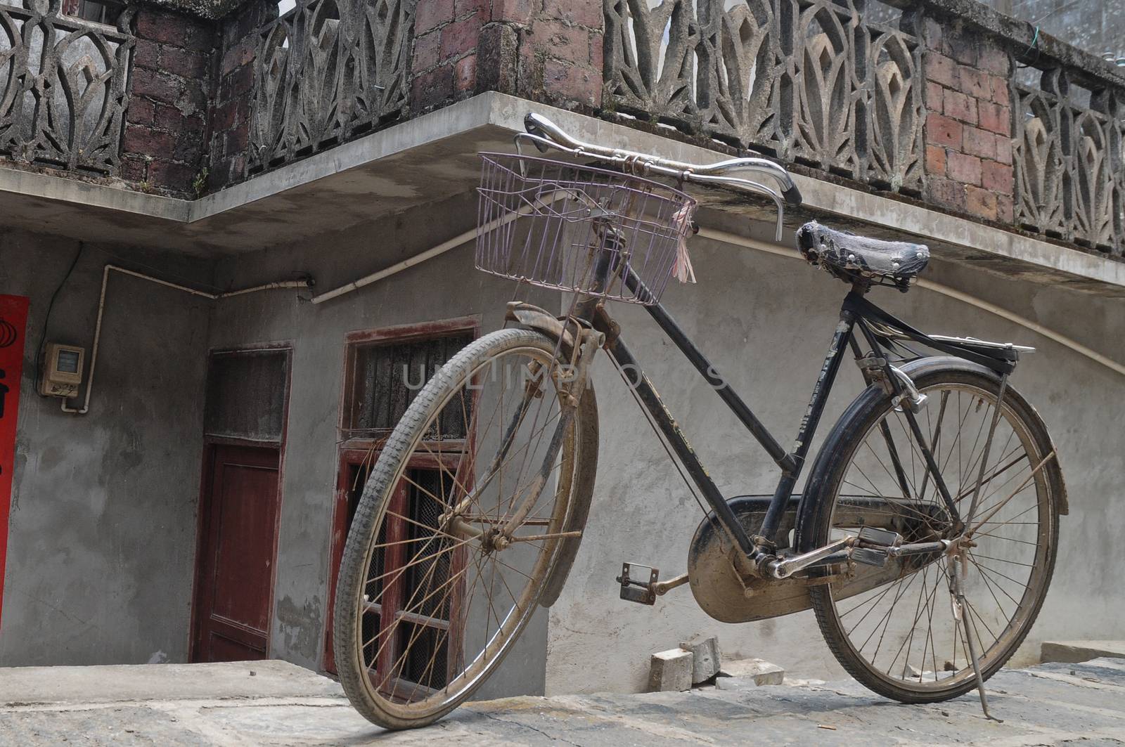 Rustic vintage bicycle in old town China by eyeofpaul