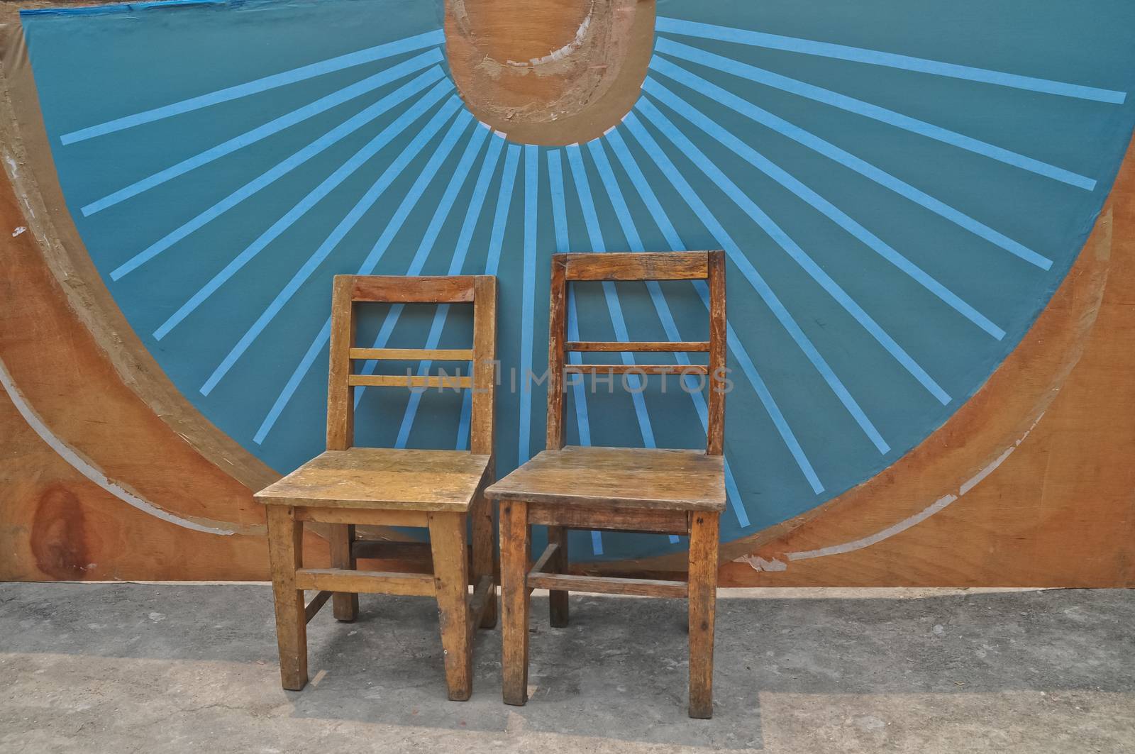 antique wooden basic chairs and blue Chinese fan wall background