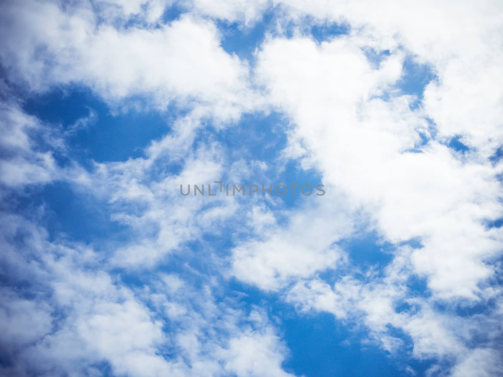 Background of white clouds floating in the blue sky.