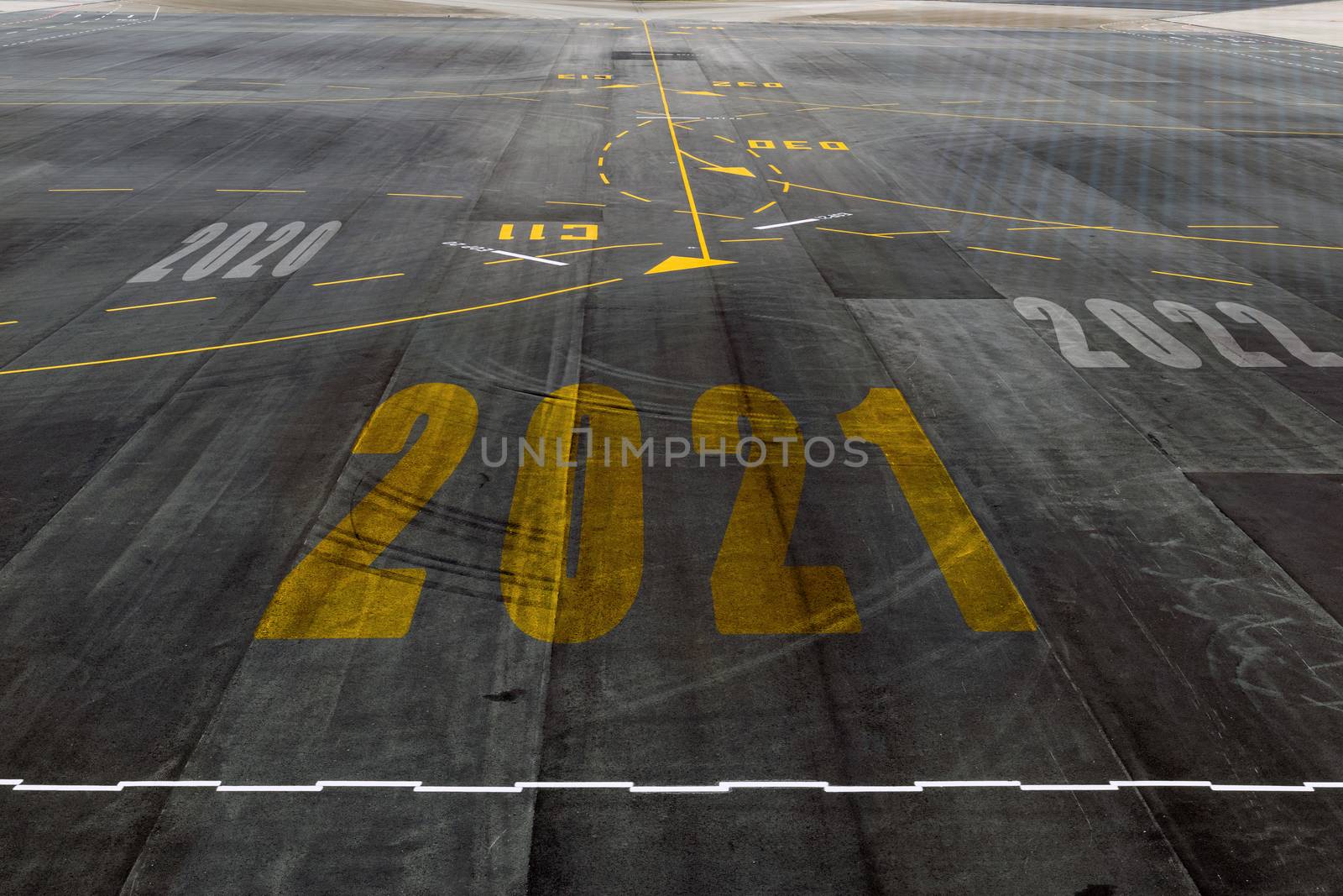 Alphabet 2021 on the airport runway floor, concept for New Year's Day.